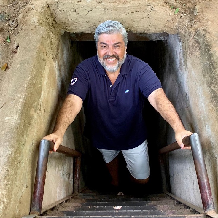 A tourist explores Cu Chi tunnels