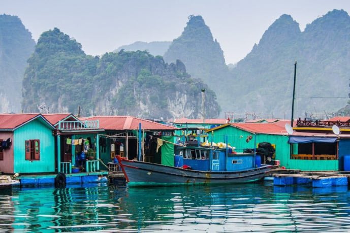 Visit Cua Van floating village near Dark and Light cave