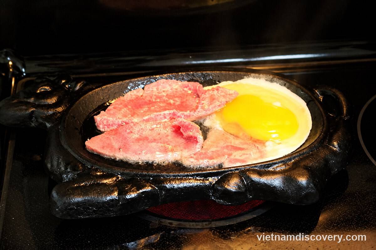 Beef and egg cooking in the cast-iron pan