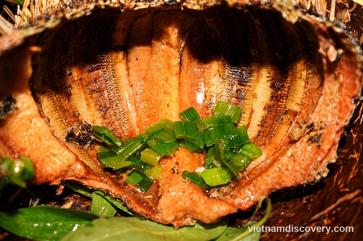 Grilled sea urchin half topped with spring onion